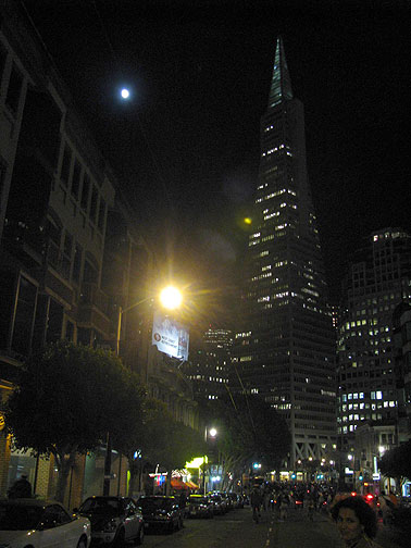 The moon and Pyramid frame Critical Mass as it re-enters Montgomery Street from Columbus.